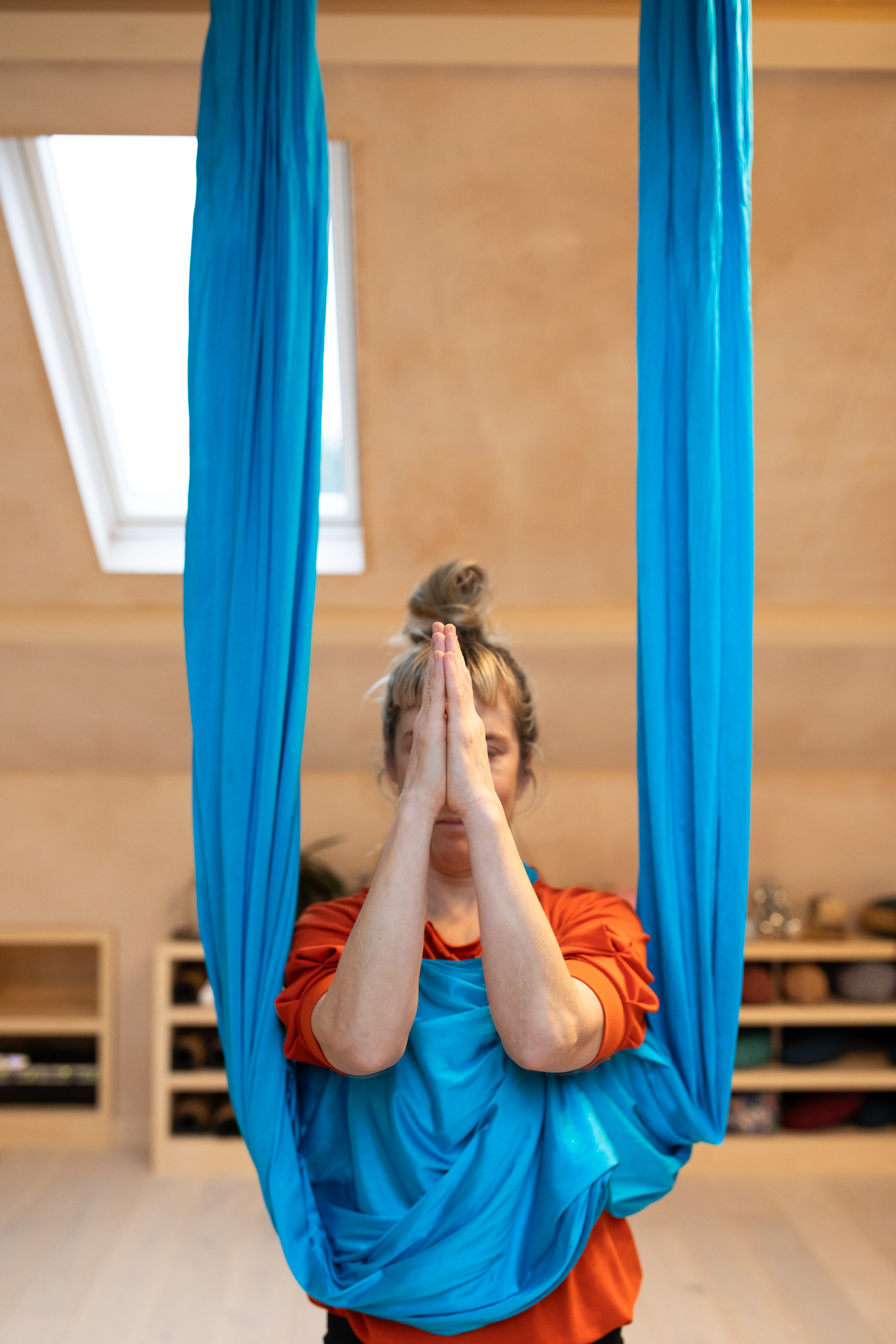 Gina in aerial silks prayer pose